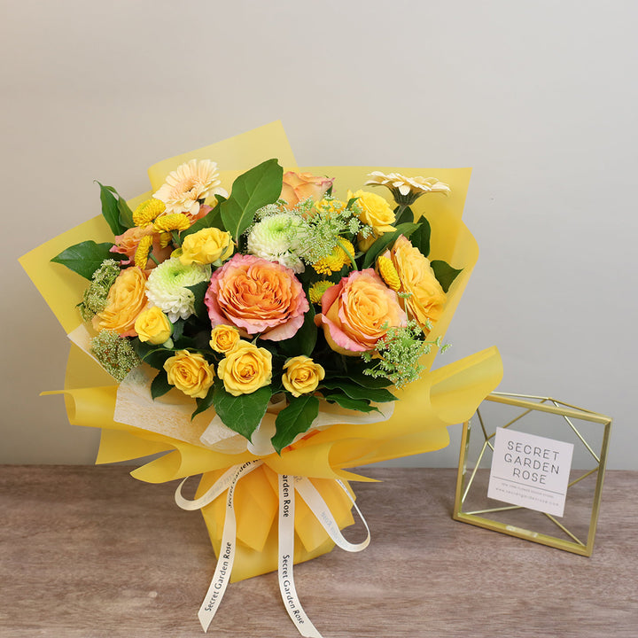 Bouquet of Free Spirit Roses, Yellow Spray Roses, Gerberas, and Pompom Mums with Lemon Leaves greeneries.