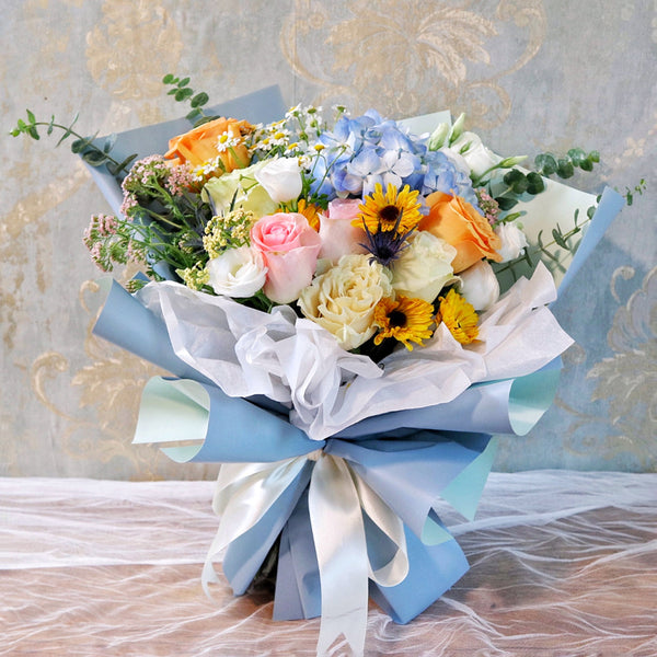 Bundle of Roses, Lisianthus, Pomp Daisies, and Blue Hydrangeas with Eucalyptus greeneries.